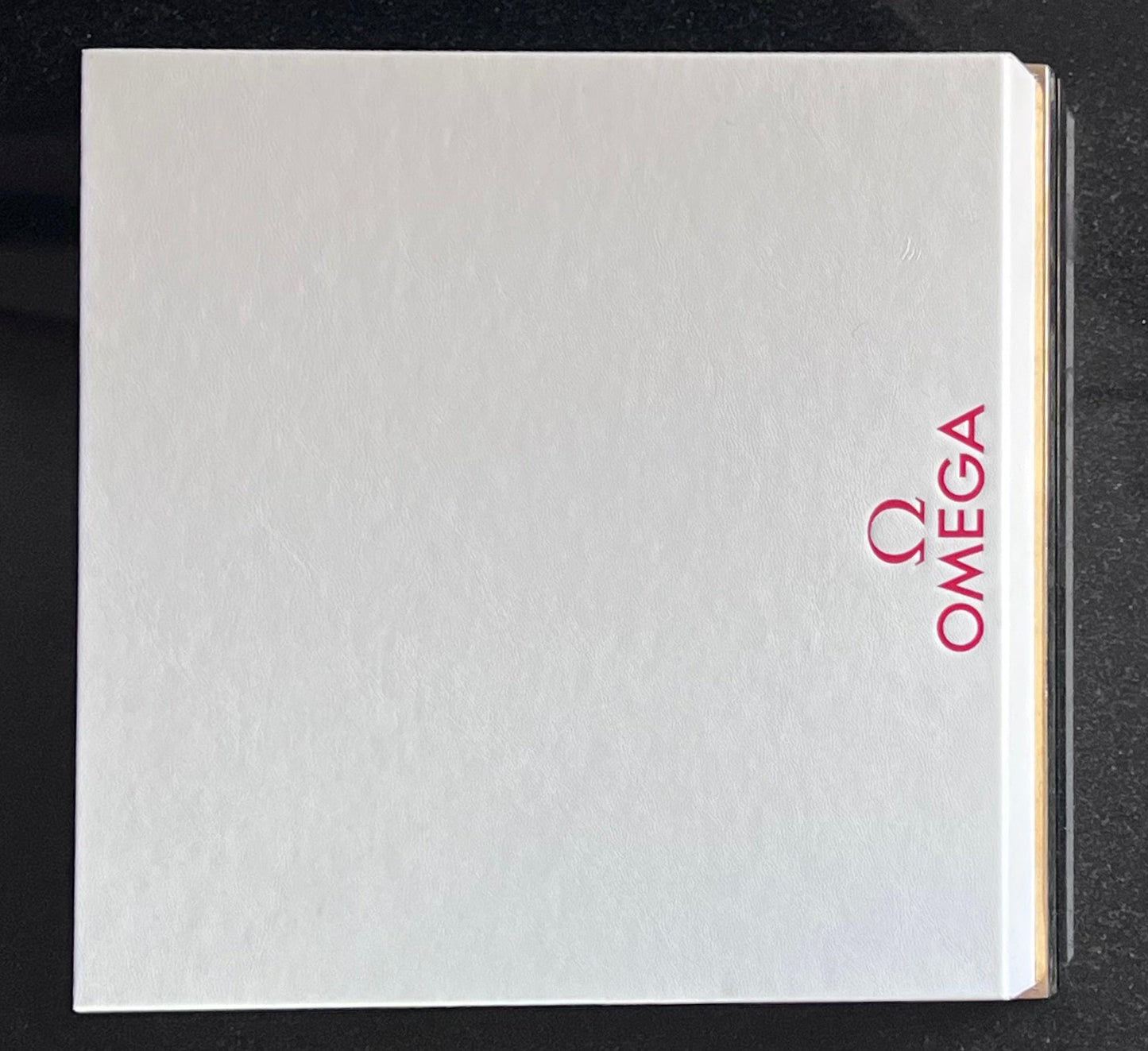 Omega Retail Display-Gold Base-White Leather-Embossed Iconic Red Omega Logo-Mint