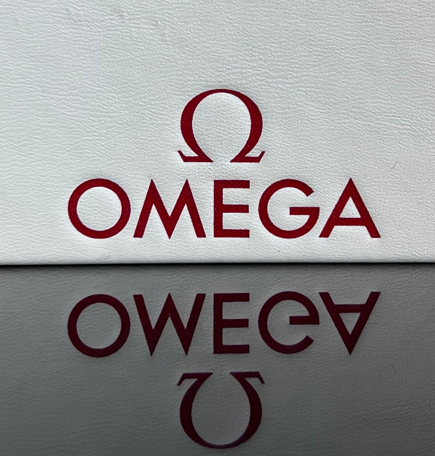 Omega Retail Display-Gold Base-White Leather-Embossed Iconic Red Omega Logo-Mint