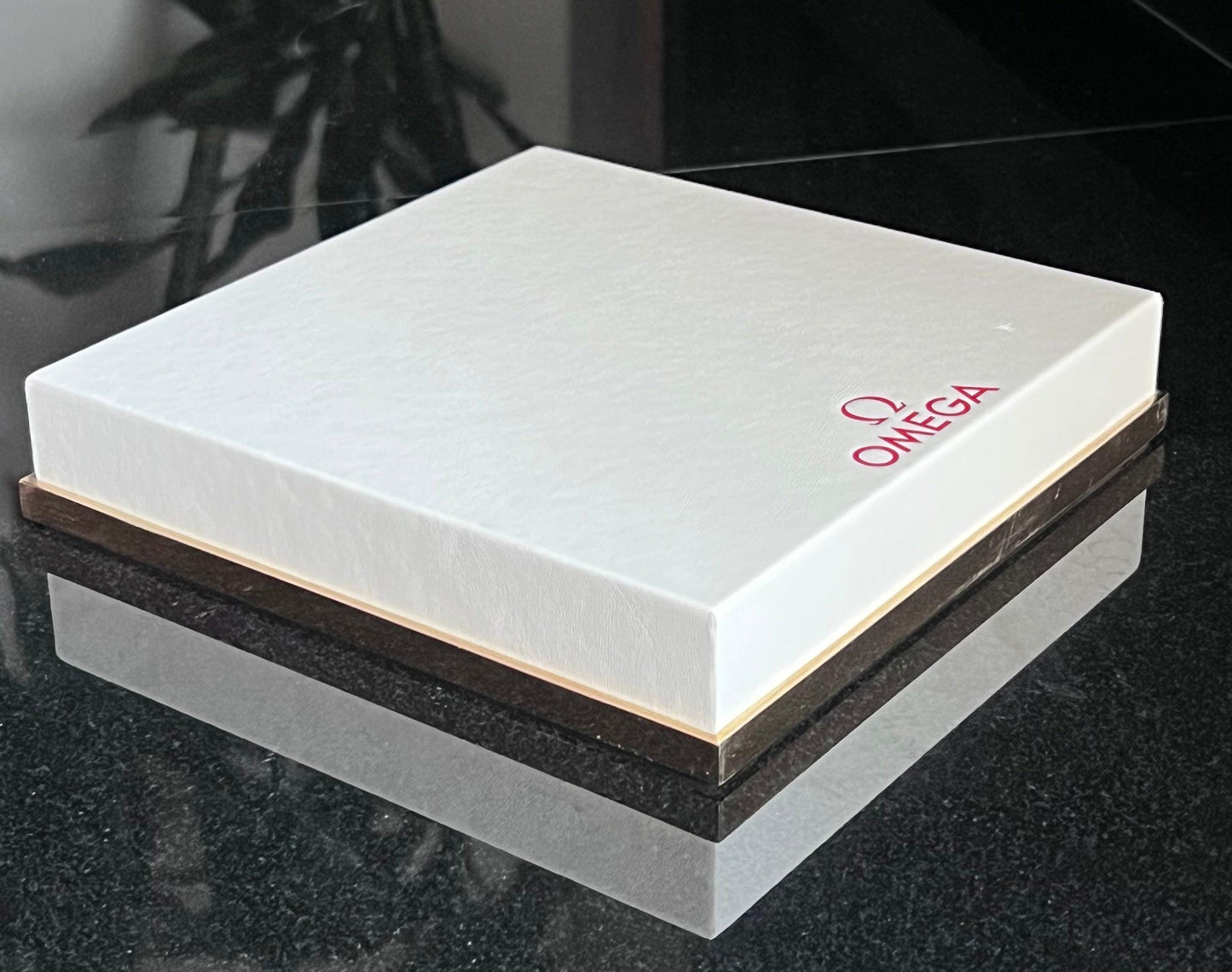 Omega Retail Display-Gold Base-White Leather-Embossed Iconic Red Omega Logo-Mint